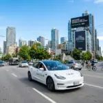 Electric Uber car driving through a city, representing Uber's commitment to sustainability